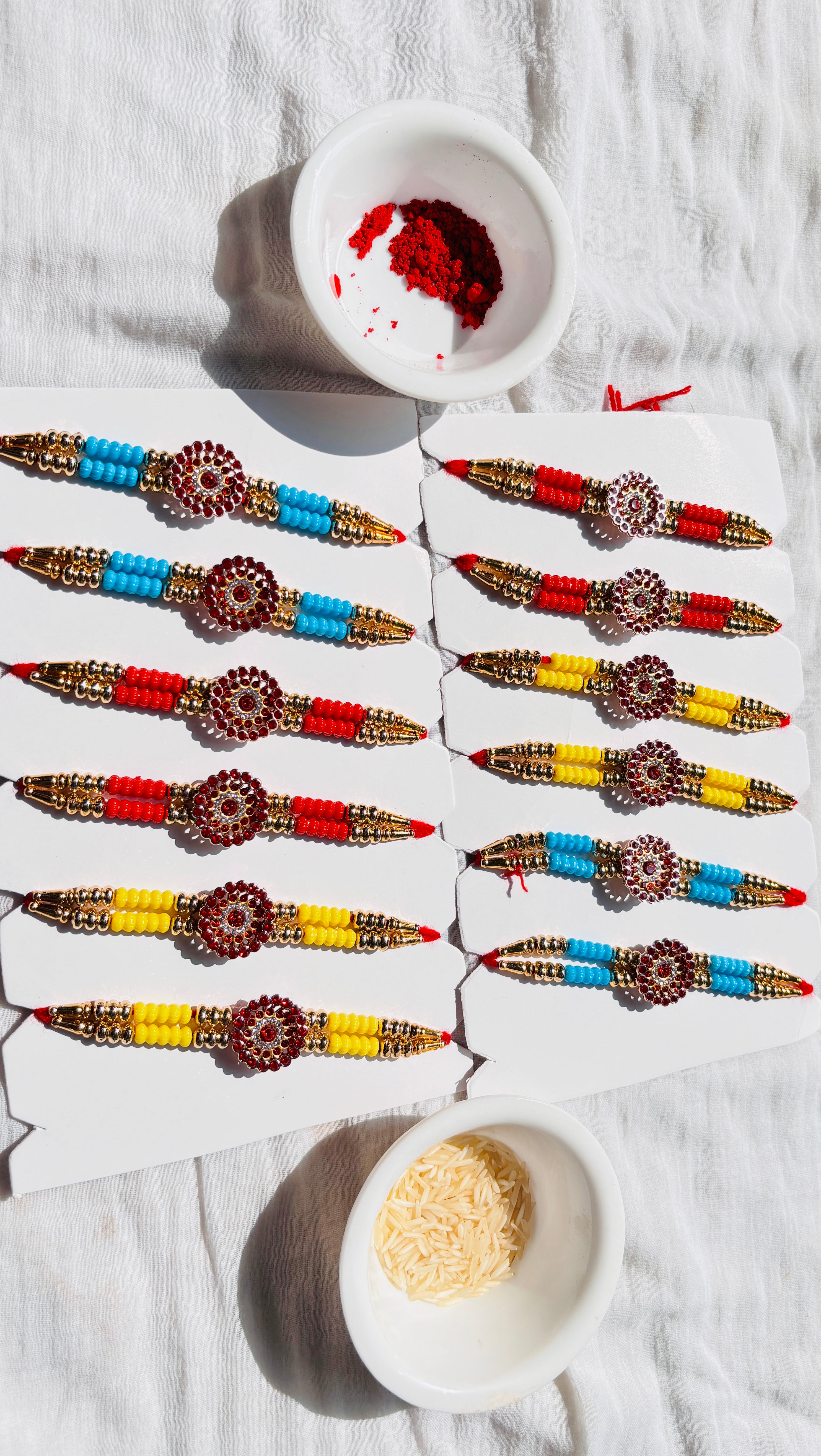 Premium Designer Rakhi Set of 12 for Brother featuring fancy handmade traditional and modern rakhi designs with decorative beads and silk threads.