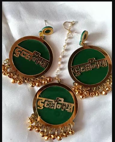 Dulhaniya Green & Gold Acrylic Gunghroo Earrings for Women & Girls featuring elegant ethnic styling with lightweight comfort and festive charm. Perfect for weddings, haldi, mehndi, festivals, parties, and traditional occasions